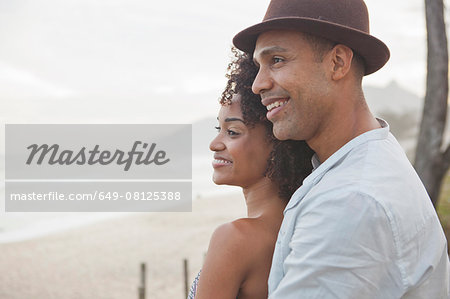 Smiling couple looking out over beach, Rio De Janeiro, Brazil