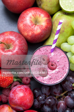 Overhead still life of fresh fruit and raspberry smoothie