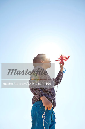 Young boy flying kite