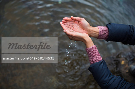 Woman holding water in cupped hands