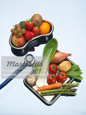 Stethoscope between trays of fresh fruits and vegetables Stethoscope between trays of fresh fruits and vegetables