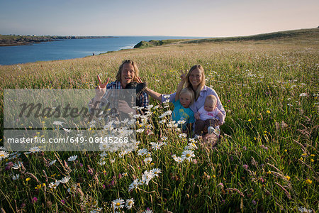 Portrait of family sitting on hillside, White strand, County Clare, Ireland