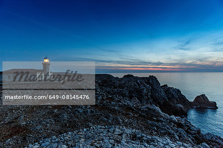 View of Punta Nati lighthouse at dusk, Menorca, Spain