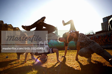 Young women breakdancing headstand freeze