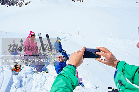 Family taking photograph on ski trip, Chamonix, France
