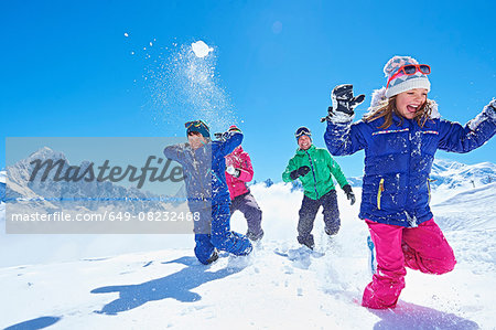 Family having snowball fight, Chamonix, France