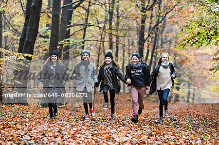 Girls running in autumn forest
