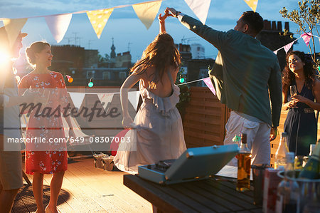 Friends dancing at early evening party