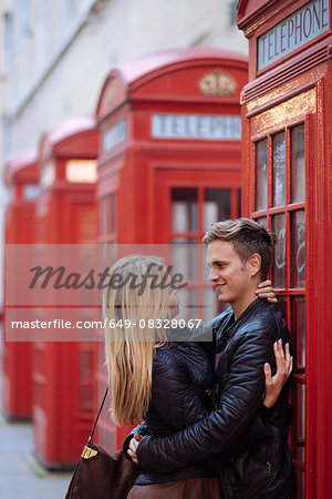 Tourists Pose For Photographs By A Traditional Red Telephone Box, London,  England Stock Photo - Alamy