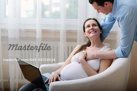 Pregnant woman sitting on a chair Stock Photo