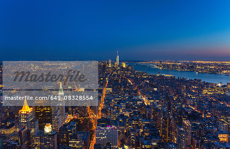 High angle cityscape of Manhattan financial district and One World Trade Centre at dusk, New York, USA