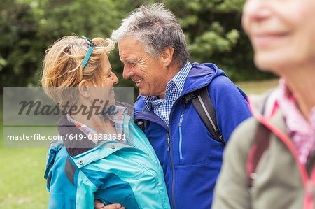 Couple hugging, face to face, smiling