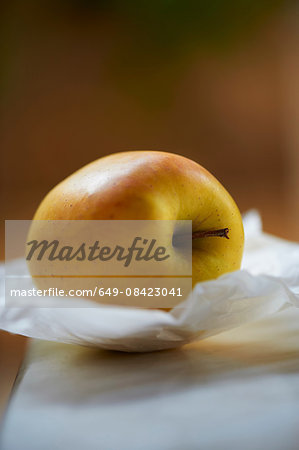 Yellow apple on greaseproof paper