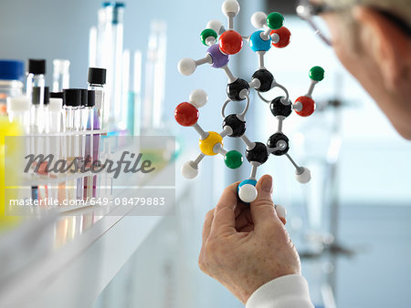 Scientist holding molecular model in laboratory