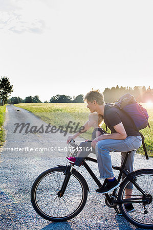 Father and baby daughter riding bike together