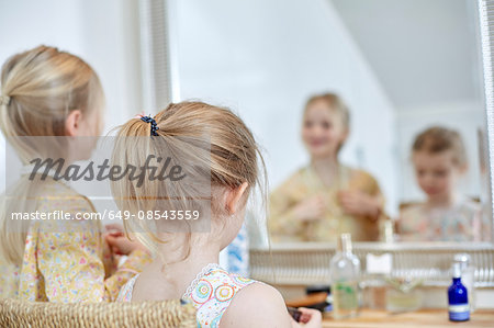 Girls playing dress-up in bedroom