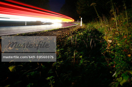Roadside with light streaks from cars