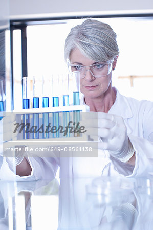 Scientist examining liquid in test tubes