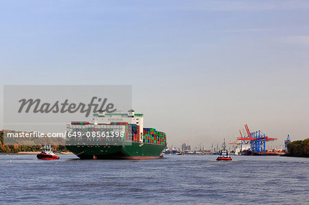 Container ship sailing on river