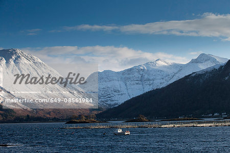 Snowy mountains over rural lake