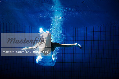 Woman in white dress underwater