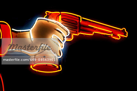 Neon sign of hand holding gun