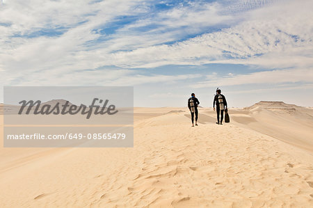 Two men in wetsuits, Great Sand Sea, Sahara Desert, Egypt, Africa