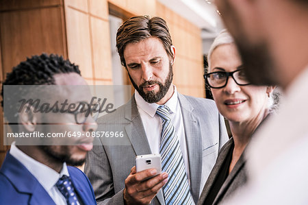 Businesspeople standing in group smiling