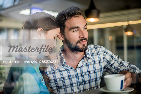 Couple at cafe window seat, Dubai, United Arab Emirates