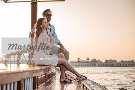 Romantic couple watching from boat at Dubai marina, United Arab Emirates