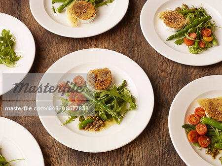 Plates of peppered fried goats cheese and salad