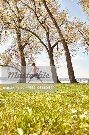 Side view of woman practising yoga by lake