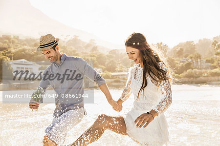 Couple splashing in sea, Cape Town, South Africa
