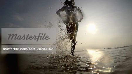 Woman in ocean splashing water