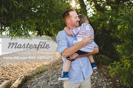 Father and young son hugging at Lake Ontario, Oshawa, Canada