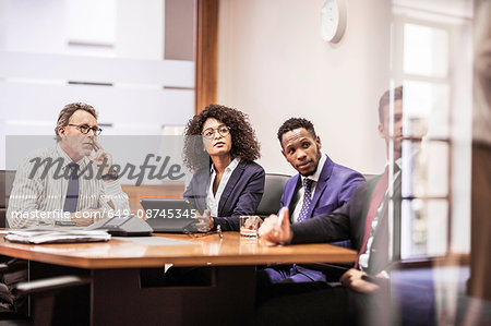 Business team listening at boardroom table