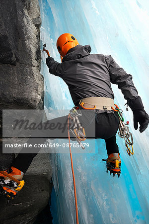 Rear view of man in cave ice climbing, Saas Fee, Switzerland