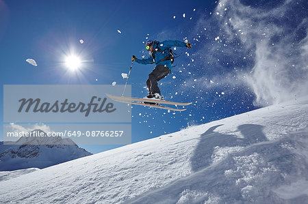 Male freestyle skier jumping mid air from mountainside, Zugspitze, Bayern, Germany