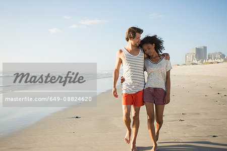 Romantic young couple strolling on beach, Cape Town, Western Cape, South Africa