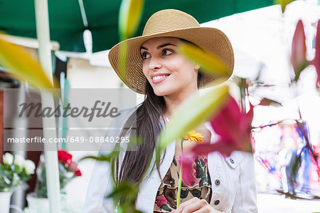 Young female tourist at flower market stall, Split, Dalmatia, Croatia