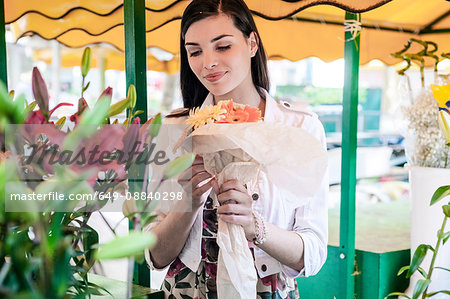 Female tourist with bunch of flowers at market stall, Split, Dalmatia, Croatia