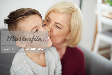 Grandmother kissing grandson's cheek