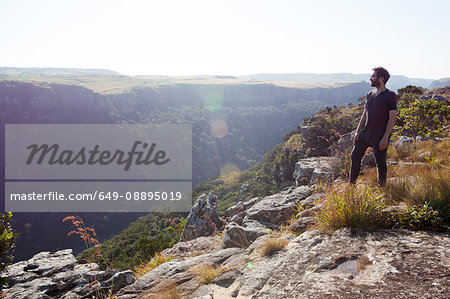 Man standing on mountain top, looking at view, South Africa