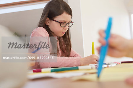 Girl drawing at table