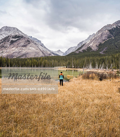 Woman standing, looking at view, rear view, Kananaskis Country; Bow Valley Provincial Park, Kananaskis, Alberta, Canada
