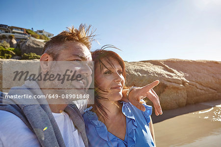 Mature couple on beach, looking at view, Cape Town, South Africa