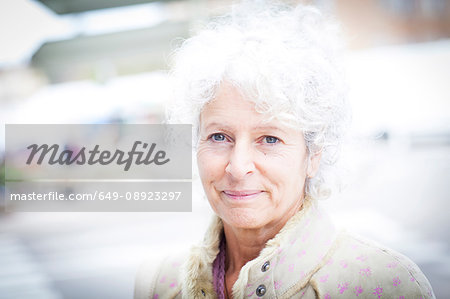 Portrait of grey haired mature woman at local french market