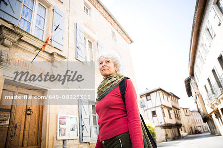 Woman in street looking away. Bruniquel, France
