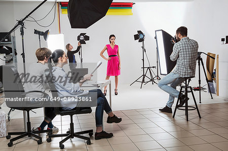Photography team and model in white backdrop photography studio shoot