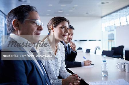 Businesswoman and men listening at office meeting